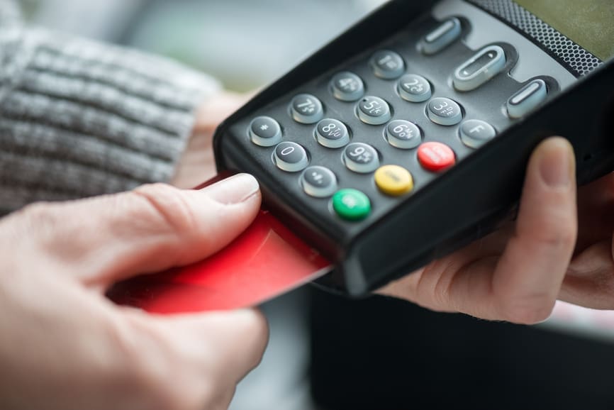 Person Using Credit Card with EMV Technology for Fraud Protection