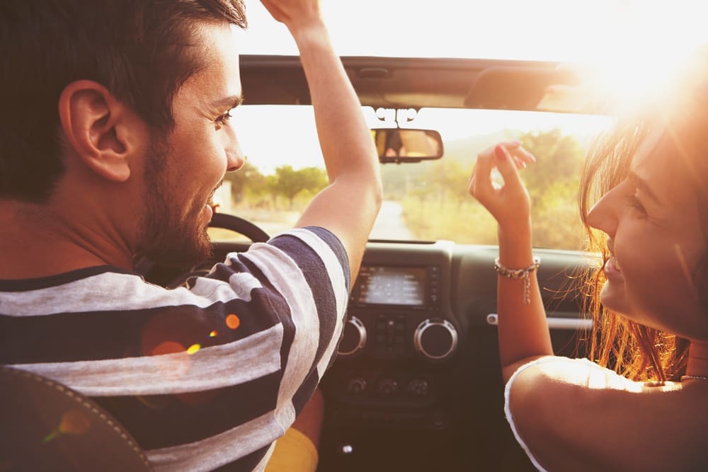 Young man and woman buying first car with first auto loan.