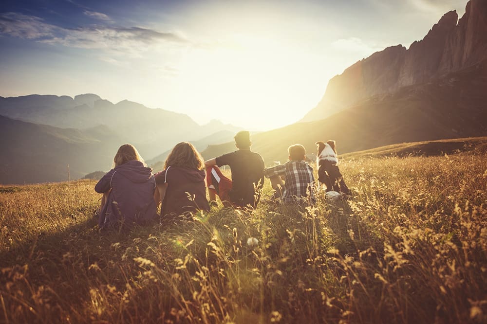 Utah family and dog enjoying a hike in the evening sun.